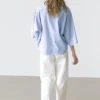 Φαρδιά μπλούζα με λεπτομέρεια γιακά με κουμπιά Φαρδιά μπλούζα με λεπτομέρεια γιακά με κουμπιά